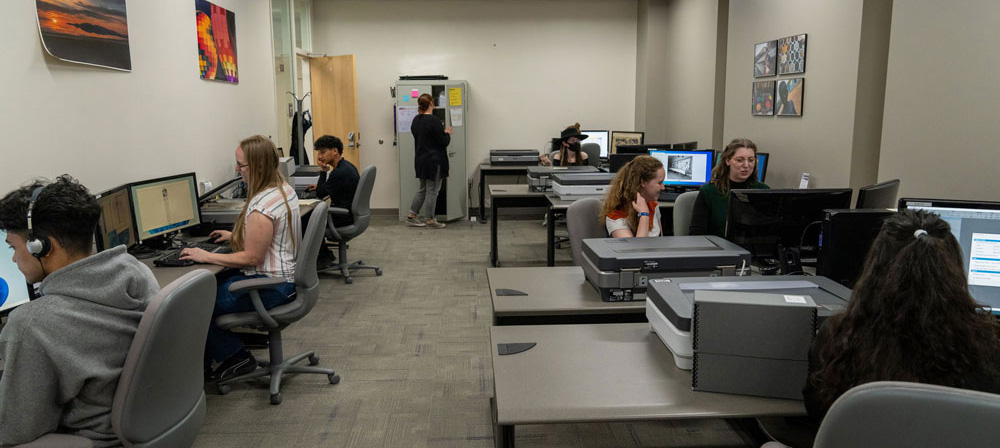 Diverse people sitting in front of computers